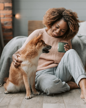 Solving separation anxiety—a woman and her Shiba Inu sit together in a cozy room